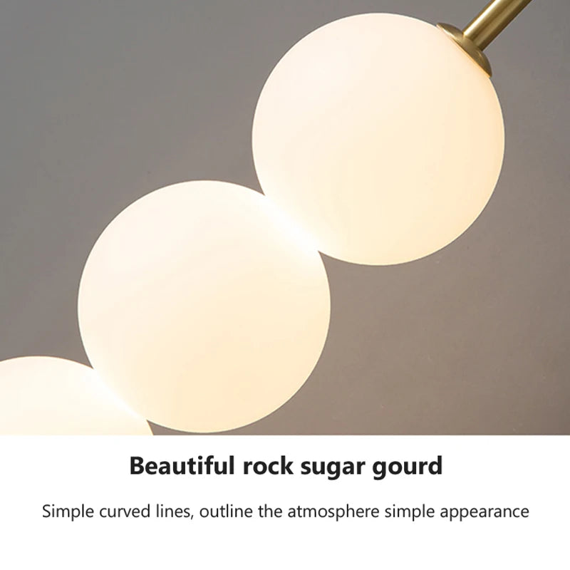 Close-up Bulb of Light-on Glass Marla Wall Light with a Golden Finish for Bedroom, Dining Room, Kitchen, and Living Room